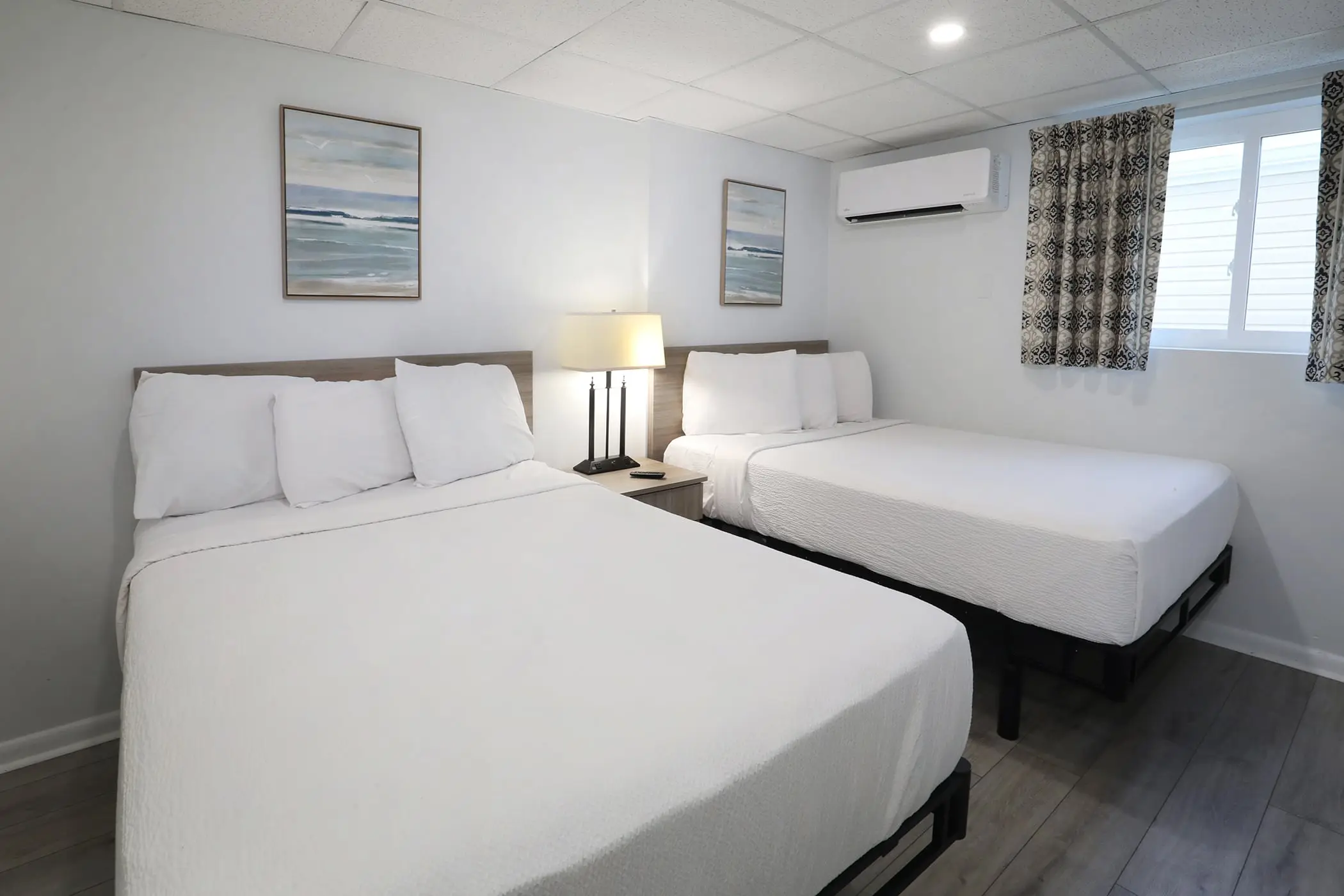 The second bedroom of a Type 8 Two-Bedroom Unit at the Matador, with two beds in white linens and a window