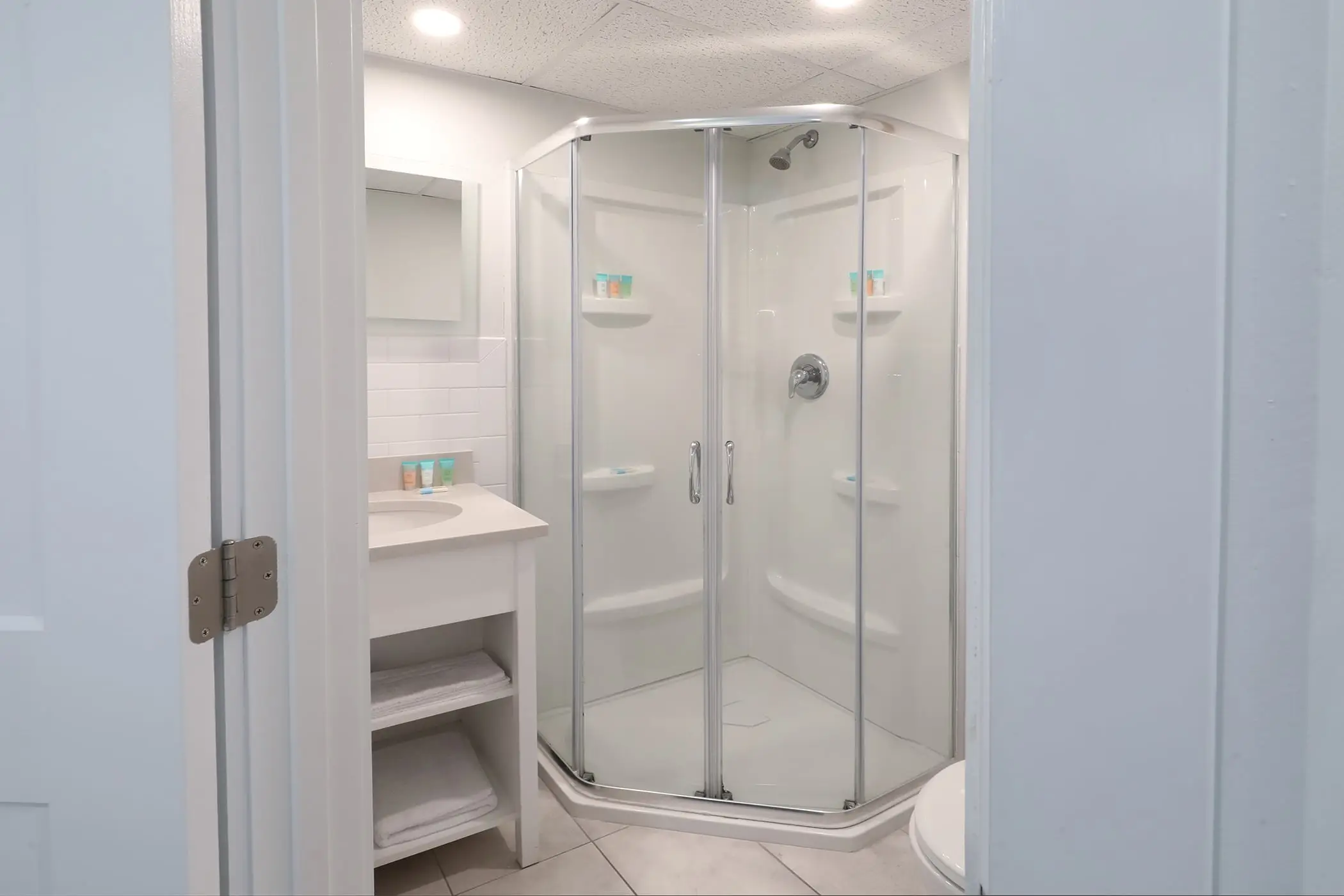 The second full bathroom in a Type 8 Two-Bedroom Unit at the Matador, with a corner glass shower and a small vanity